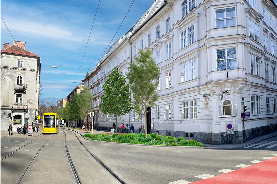 Zu sehen ist: eine STraßenbahn, eine Kreuzung, ein weißes Gebäude in Graz